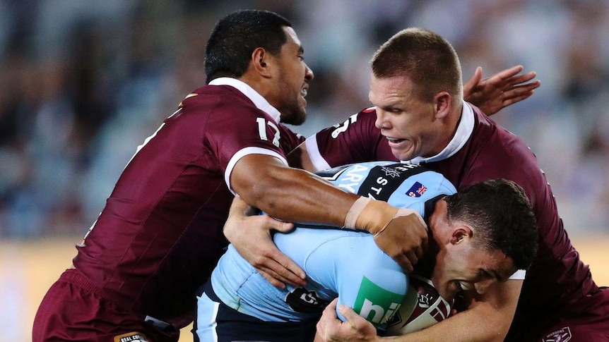 Nathan Cleary of the Blues is tackled by the Maroons defence during Game 2 of the 2020 State of Origin series between the NSW Blues and QLD Maroons at ANZ Stadium in Sydney, Wednesday, November 11, 2020