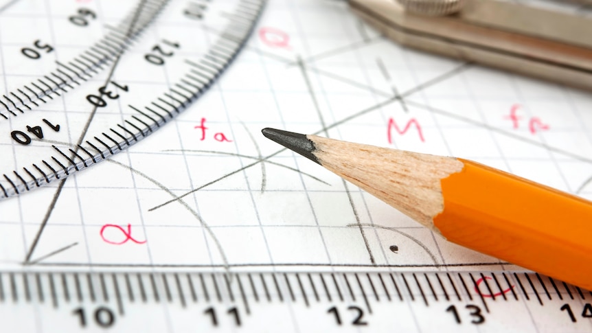 A pencil sits on paper that shows angles and a plastic ruler