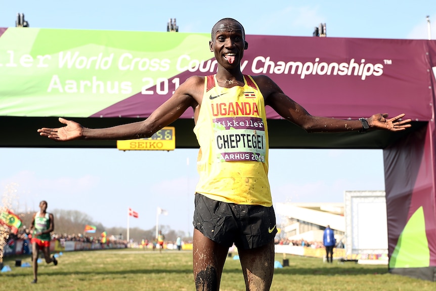 A Ugandan male athlete celebrates winnig the 2019 World Athletics Cross Country Championships.