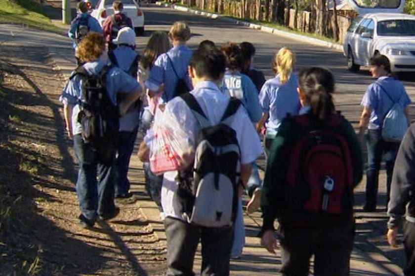 Qld high school kids walking along a street in Brisbane.