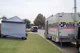 A police command vehicle and forensics tent outside the backyard to a home on Nyinda Entrance in South Guildford.