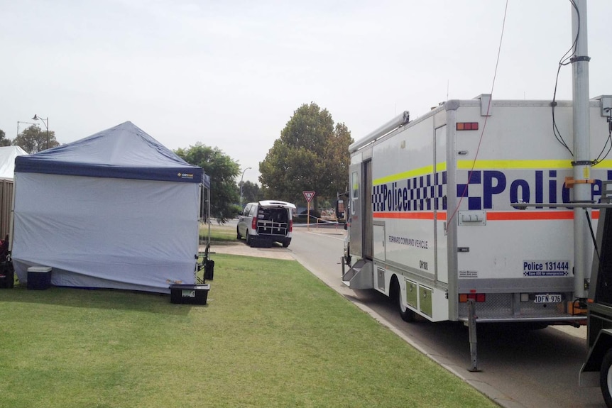 A police command vehicle and forensics tent outside the backyard to a home on Nyinda Entrance in South Guildford.