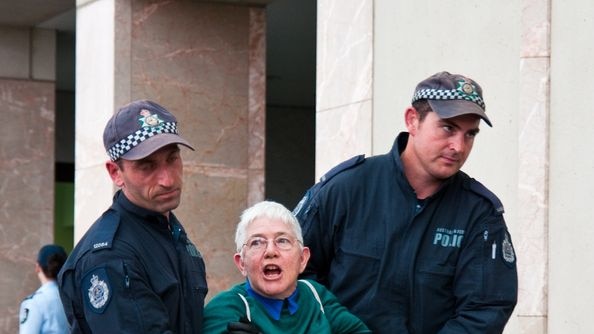A protester gets carried away from the entrance of Parliament House in Canberra