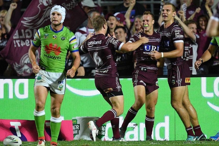 Daly Cherry-Evans celebrates with Manly teammates after his try against Canberra