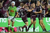Daly Cherry-Evans (2ndR) and his Manly teammates celebrate a try against Canberra.