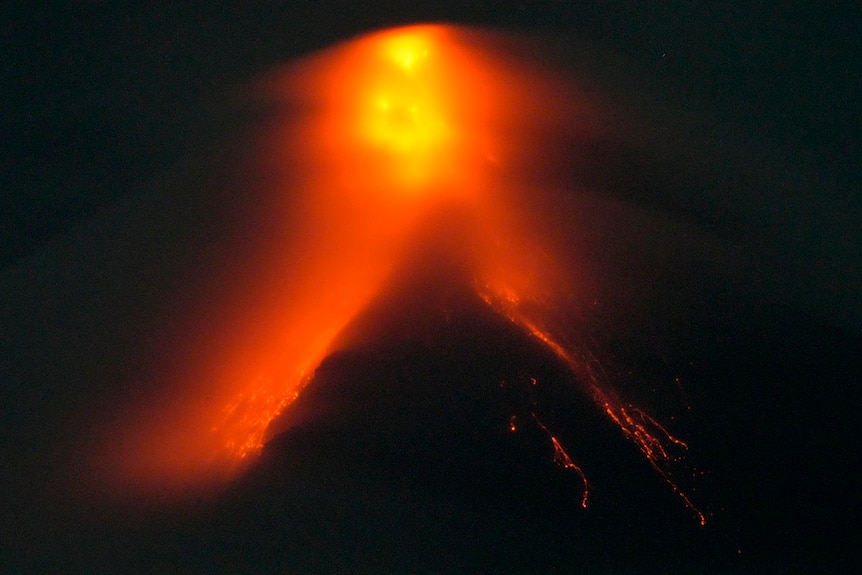 Mayon volcano belches red-hot emissions down it's slope as seen from Legaspi, Albay province.