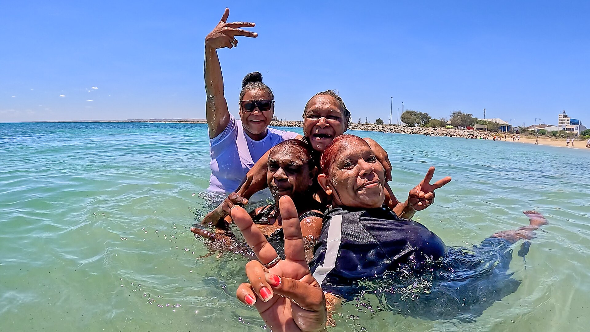 A group of people swimming in clear blue water