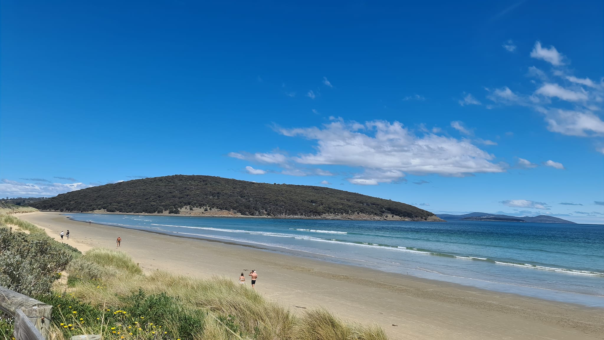 people jogging and walking on the sand at Carlton Beach Tasmania