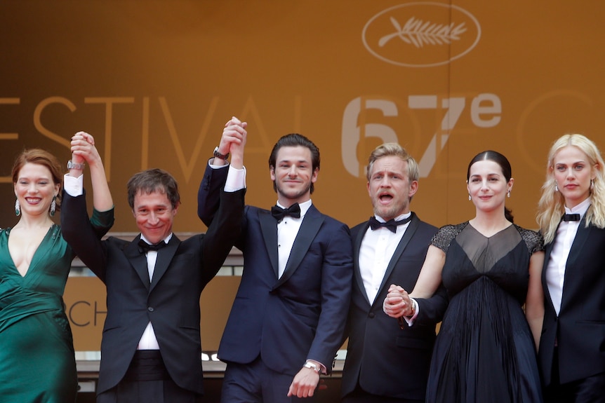 Gaspard Ulliel (centre) poses for photos with cast.