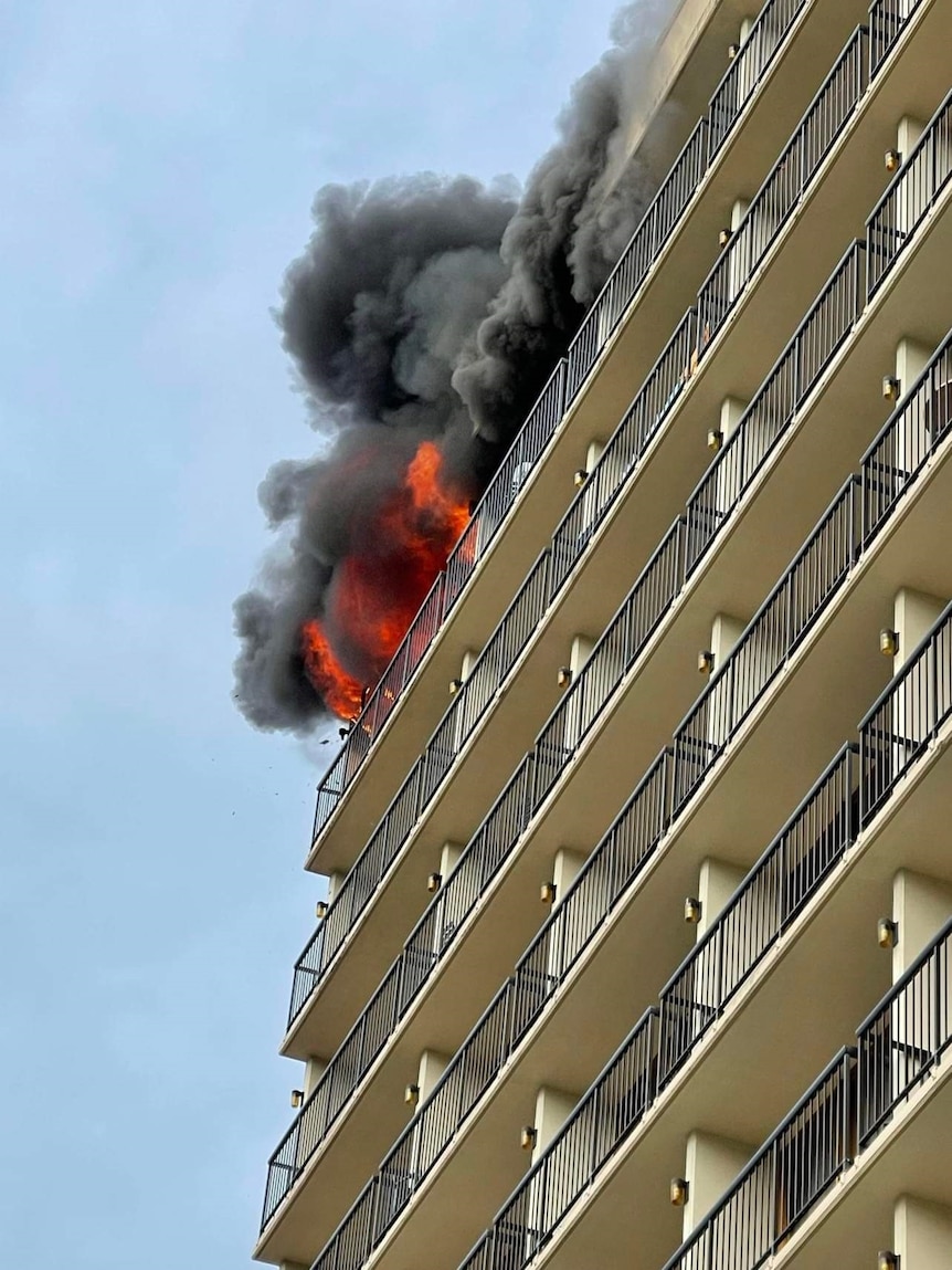 A fire burning on the top floor of a high-rise hotel 