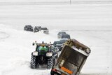Heavy snowfall: a tractor removes a truck blocked by the snow near Arras in northern France.