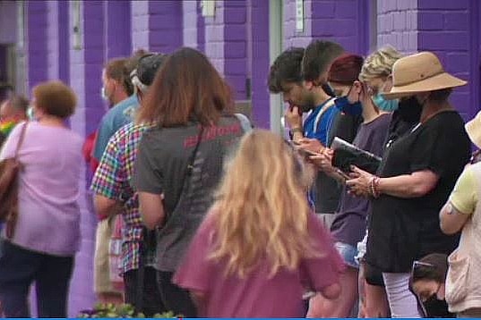 people waiting in a line to get tested