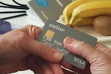 A close-up of a person holding a credit card