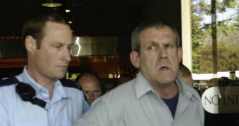 Bradley John Murdoch escorted by a police officer.