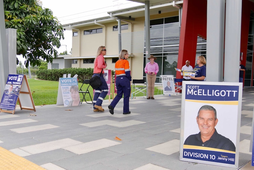 Two women in high vis walk into pre-poll