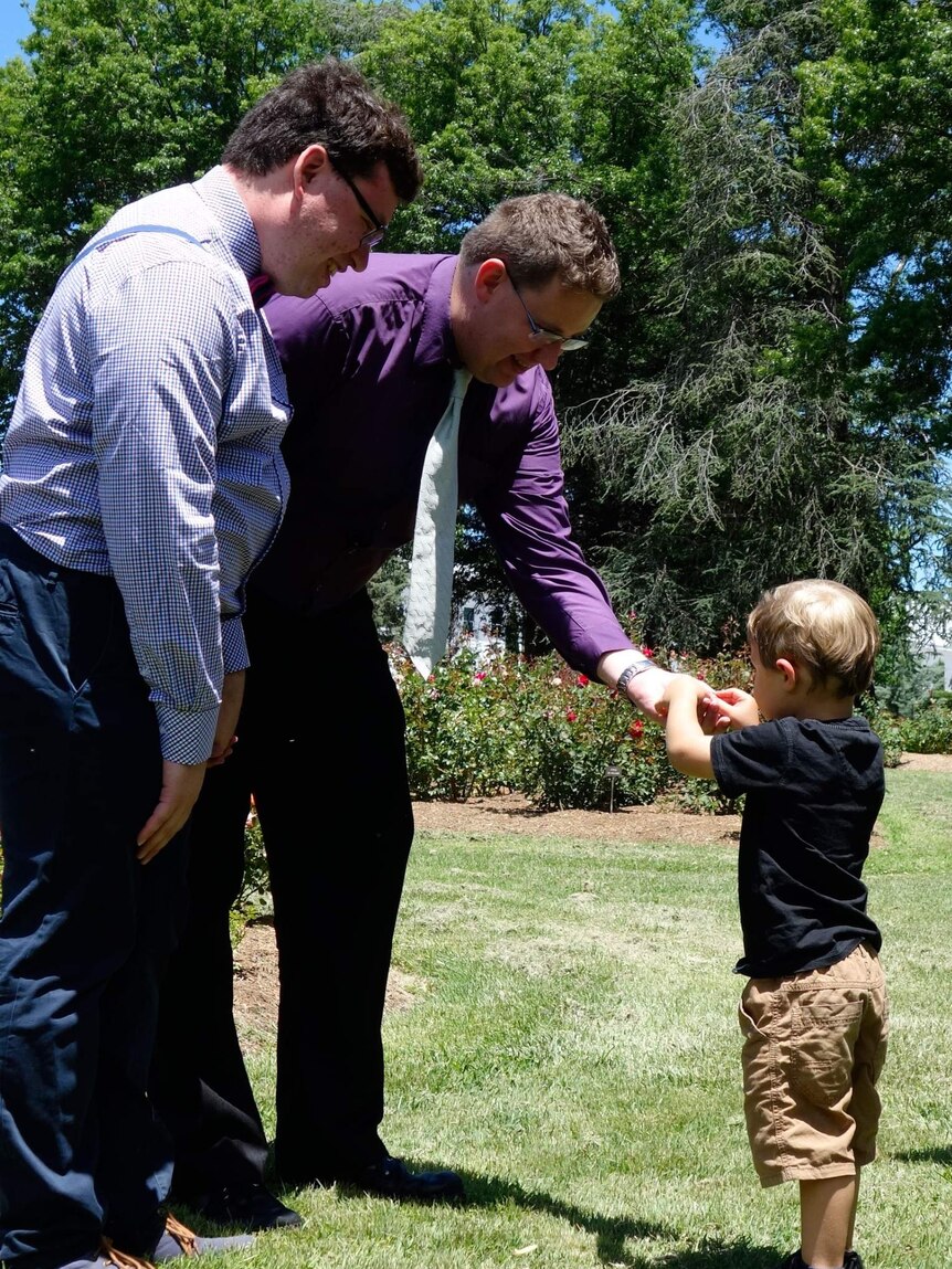 Ulises Garcia and Craig Berry with their ring bearer and nephew Henry at their wedding on Saturday.