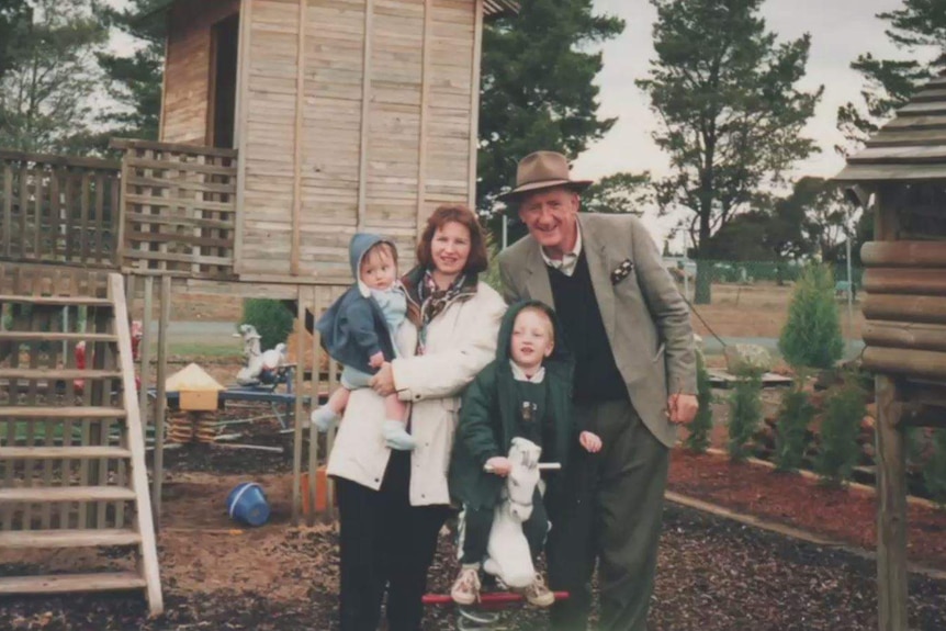 Photograph of a family of husband, wife and two sons in a playground