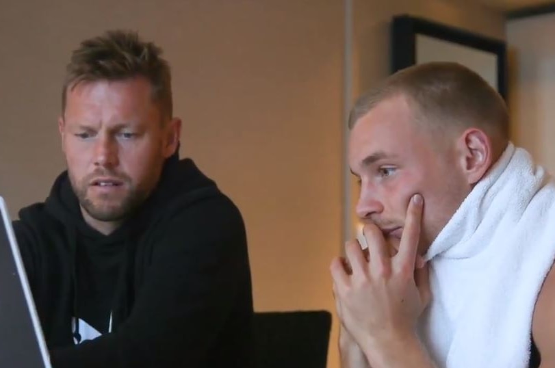 Sam Mitchell and James Worpel look studiously at a laptop.