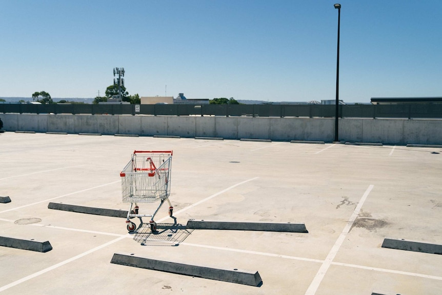 A trolley in an empty car park.