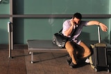 Qantas passenger outside the domestic terminal at Sydney airport