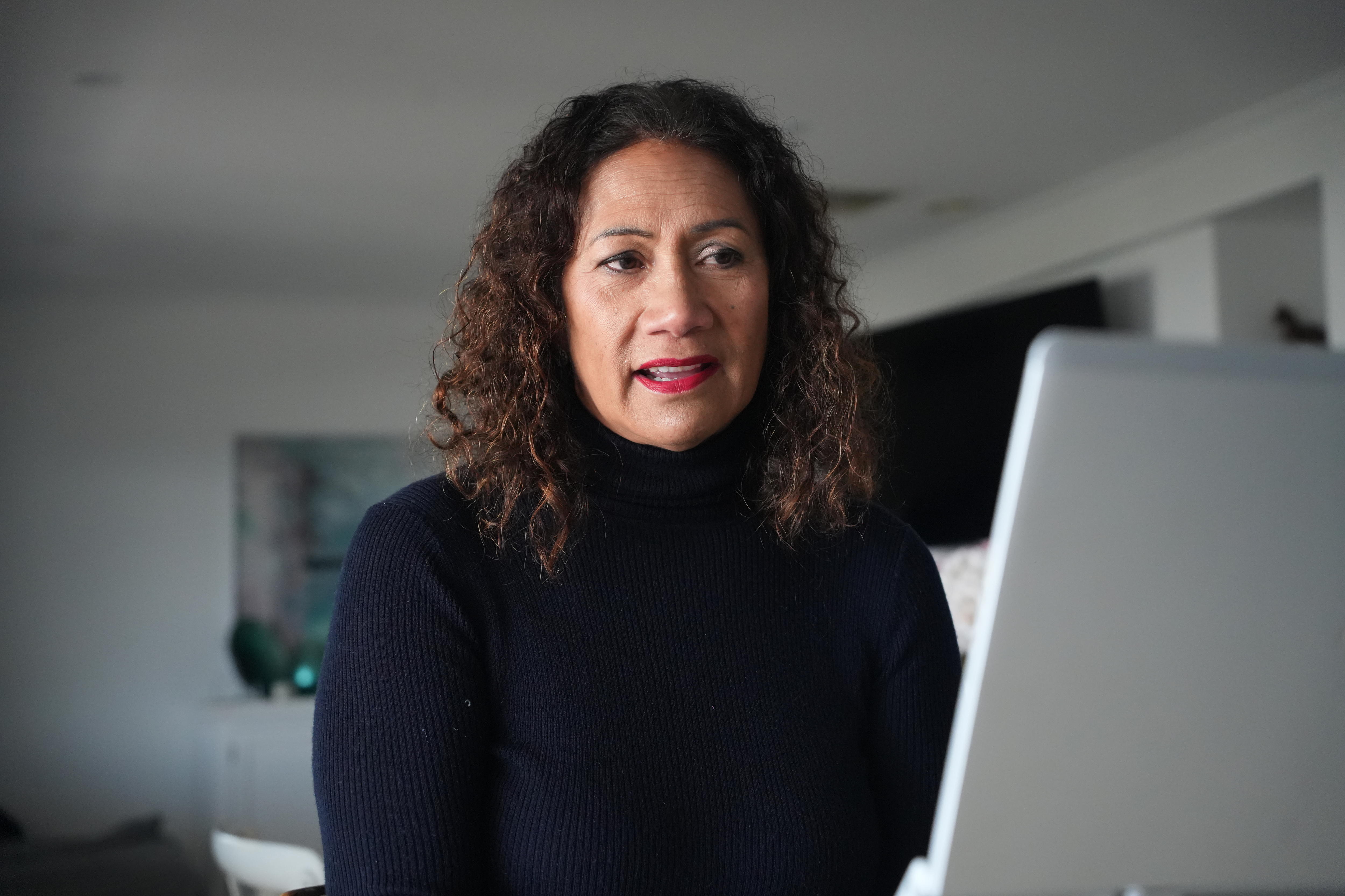 Dorothy Maafu looking at a laptop screen.