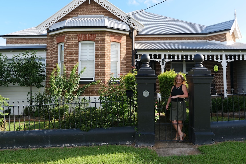 Leah Parkes outside her 1889 home, 'Wingham House.'