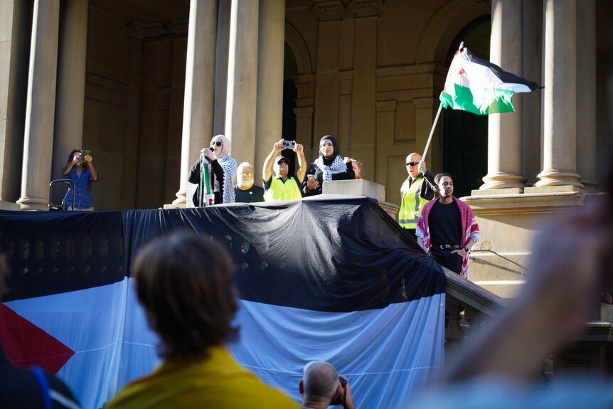 supporters of palestine address a rally at town hall in sydney on monday october 9 