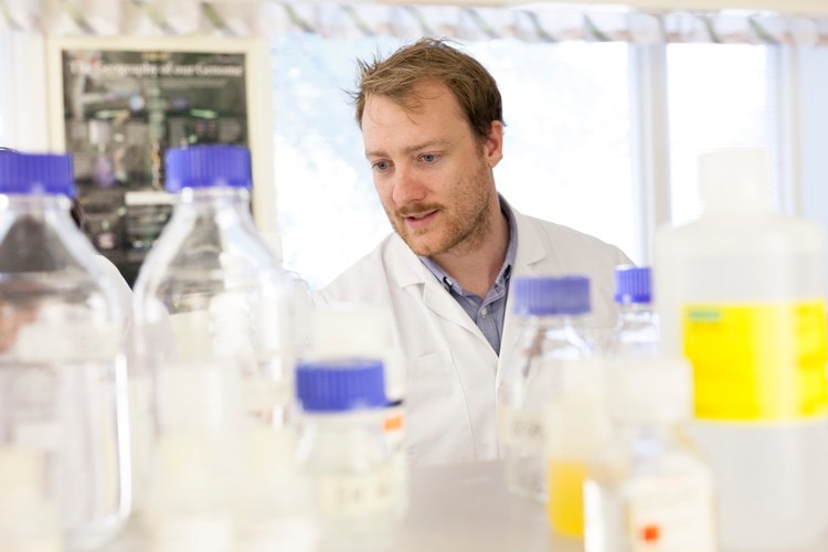 A European man is standing in a lab