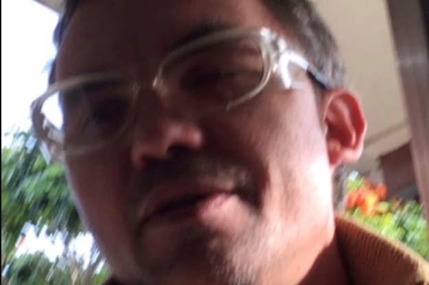 blurry photograph of man wearing safety glasses
