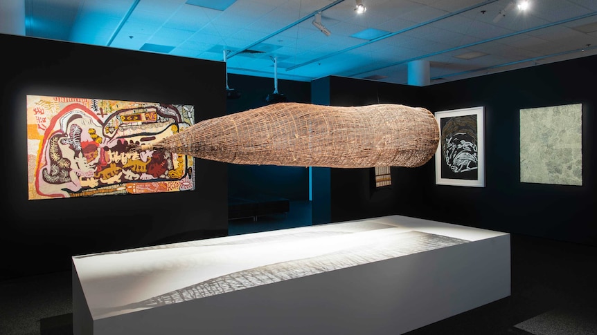 Various artworks installed for the 2022 NATSIAA awards, a large tradition fish trap is in the centre