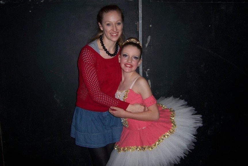 A young woman and a girl in a tutu.