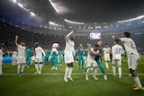 A group of Real Madrid players leap in the air and hug each other after the final whistle in the Champions League final. 