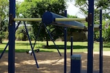 A playground with swings is pictured