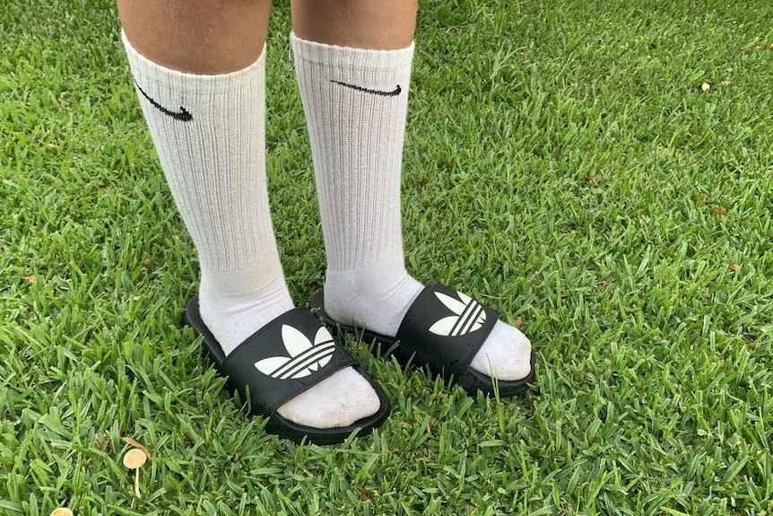 white knee length socks with black slides