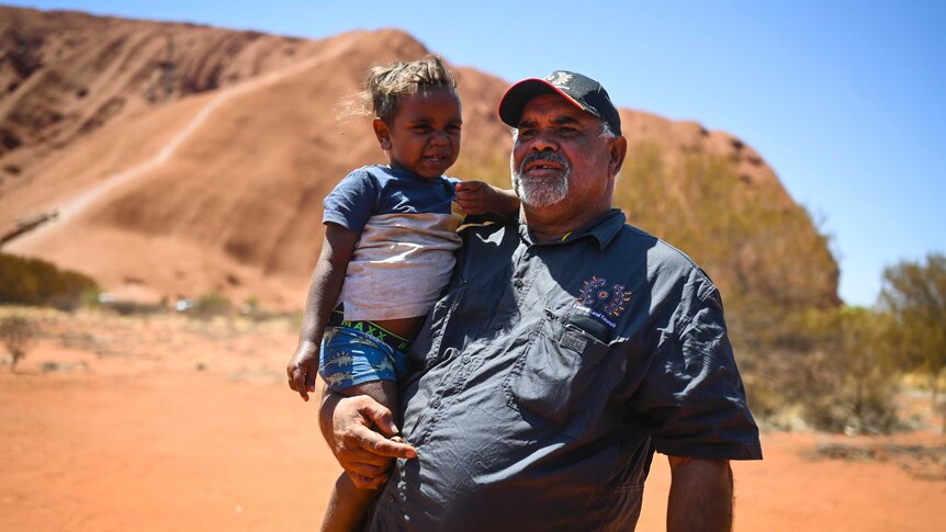 Uluru traditional owner Sammy Wilson pictured with his grandson Jacob.