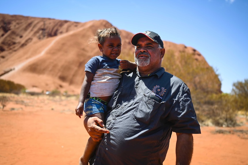 Uluru traditional owner Sammy Wilson pictured with his grandson Jacob.