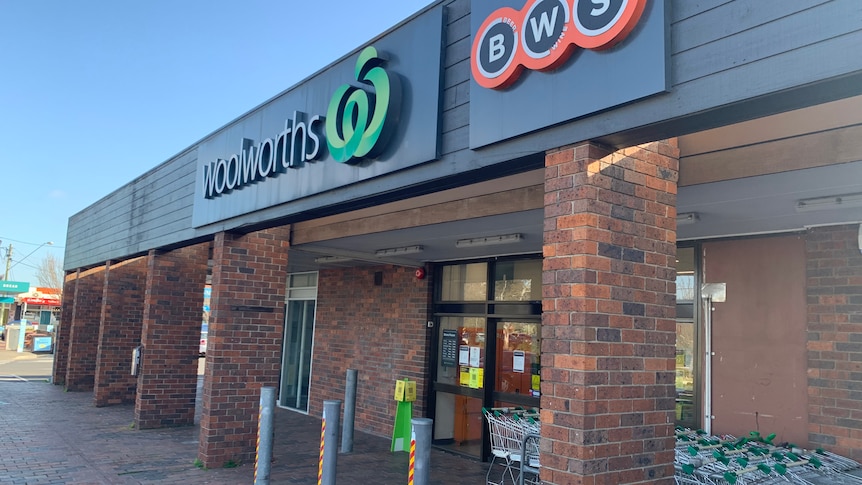 The outside of the Woolworths supermarket, with brick pillars and a BWS sign.