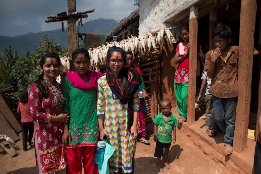 Nepali school girls outside building with kids