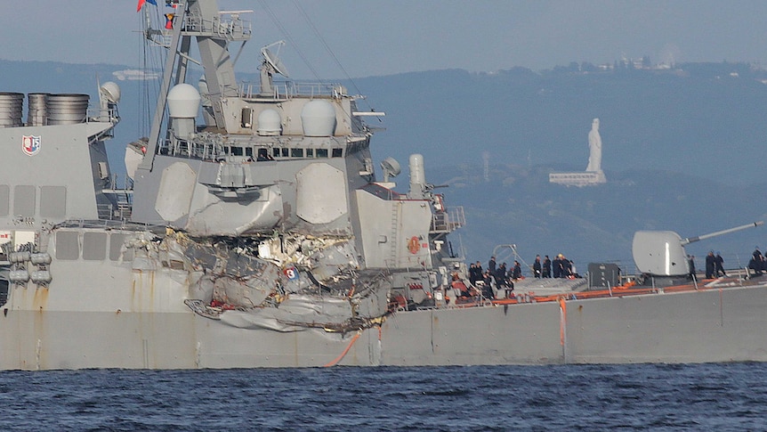 A large damaged section spreads along the side of the USS Fitzgerald