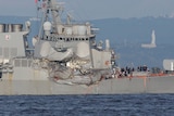 A large damaged section spreads along the side of the USS Fitzgerald