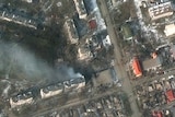 An aerial shot showing burning apartment buildings.