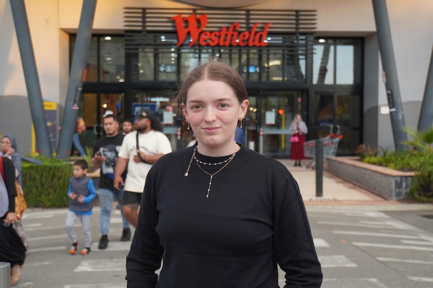 A young woman named Jade Watson stands outside a shopping centre. 