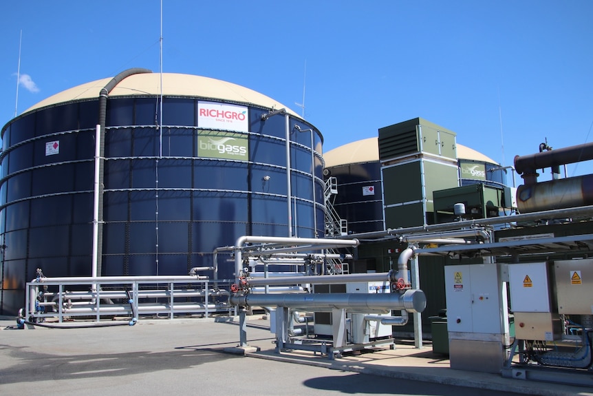 A wide shot of two large tanks and electrical infrastructure