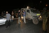 Jewish settlers stop at an Israeli army roadblock