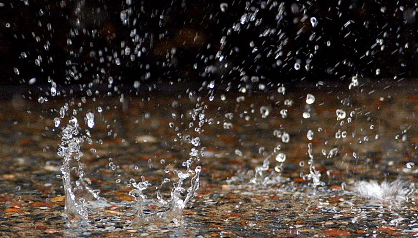 Raindrops hitting the ground.
