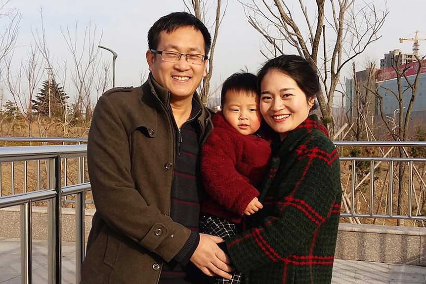 Wang Quanzhang, left, and his wife Li Wenzu poses for a photo with their son at a park in eastern China's Shandong province.