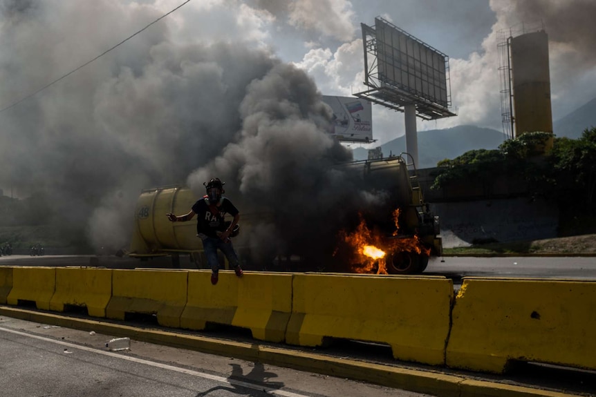 A burning truck explodes during protests.