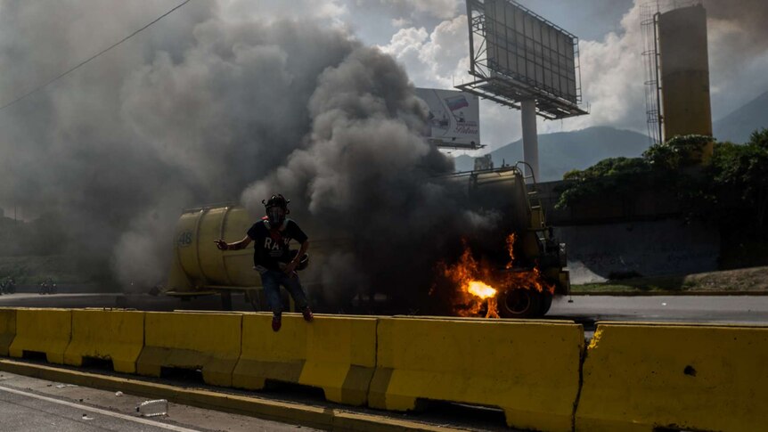 A burning truck explodes during protests.