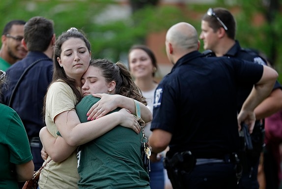Two students hug during a vigil at the University of North Carolina-Charlotte on May 1, 2019.