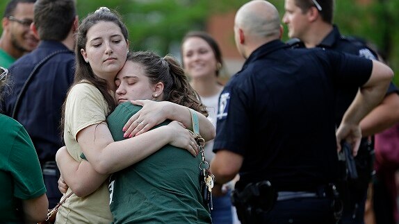 Two students hug during a vigil at the University of North Carolina-Charlotte on May 1, 2019.